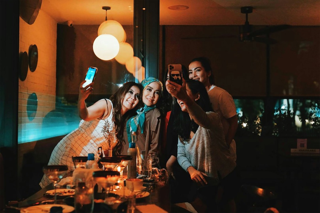 Friends taking a selfie in a small bar